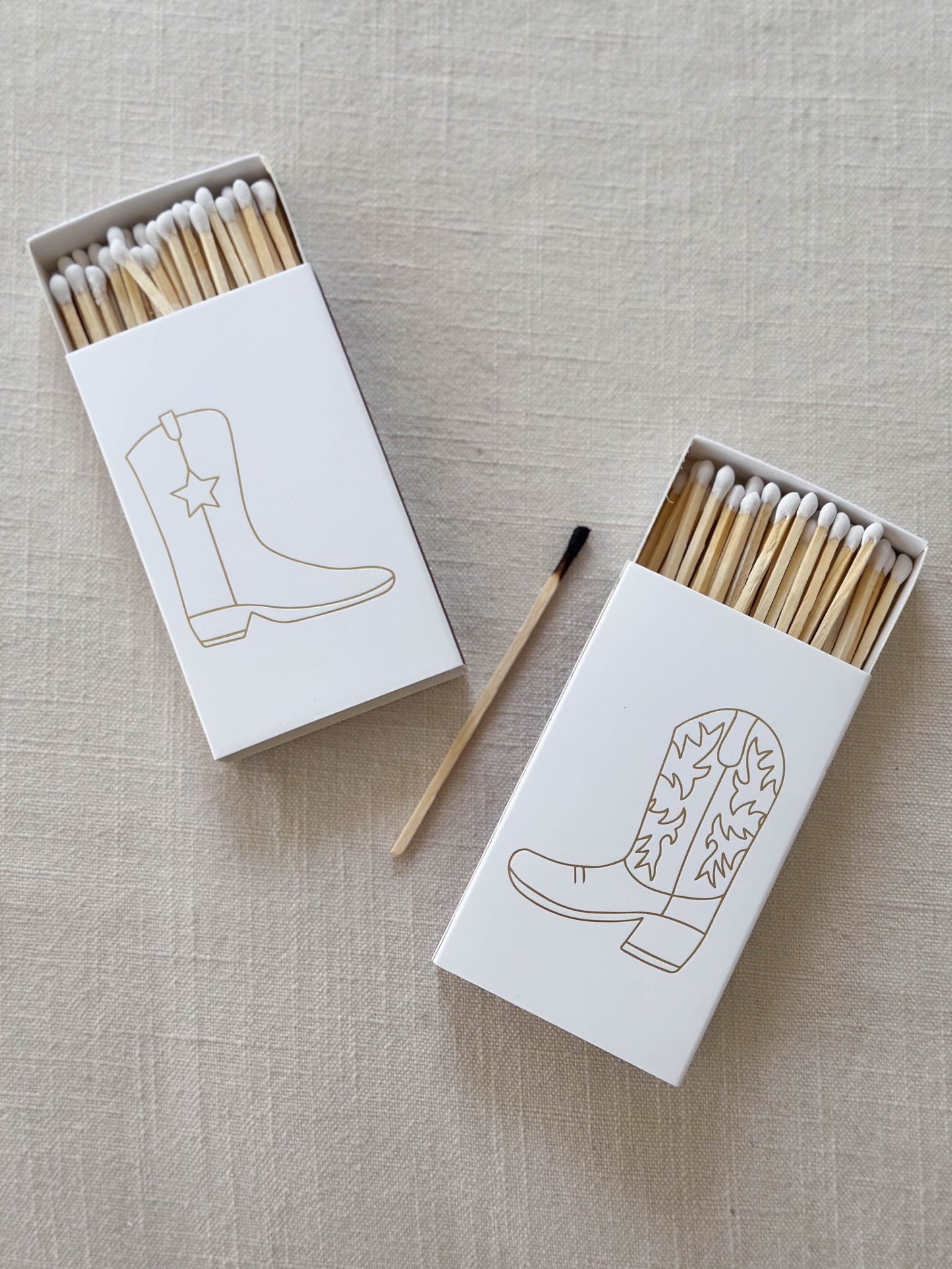 White cowboy boot matches decorated with gold foil